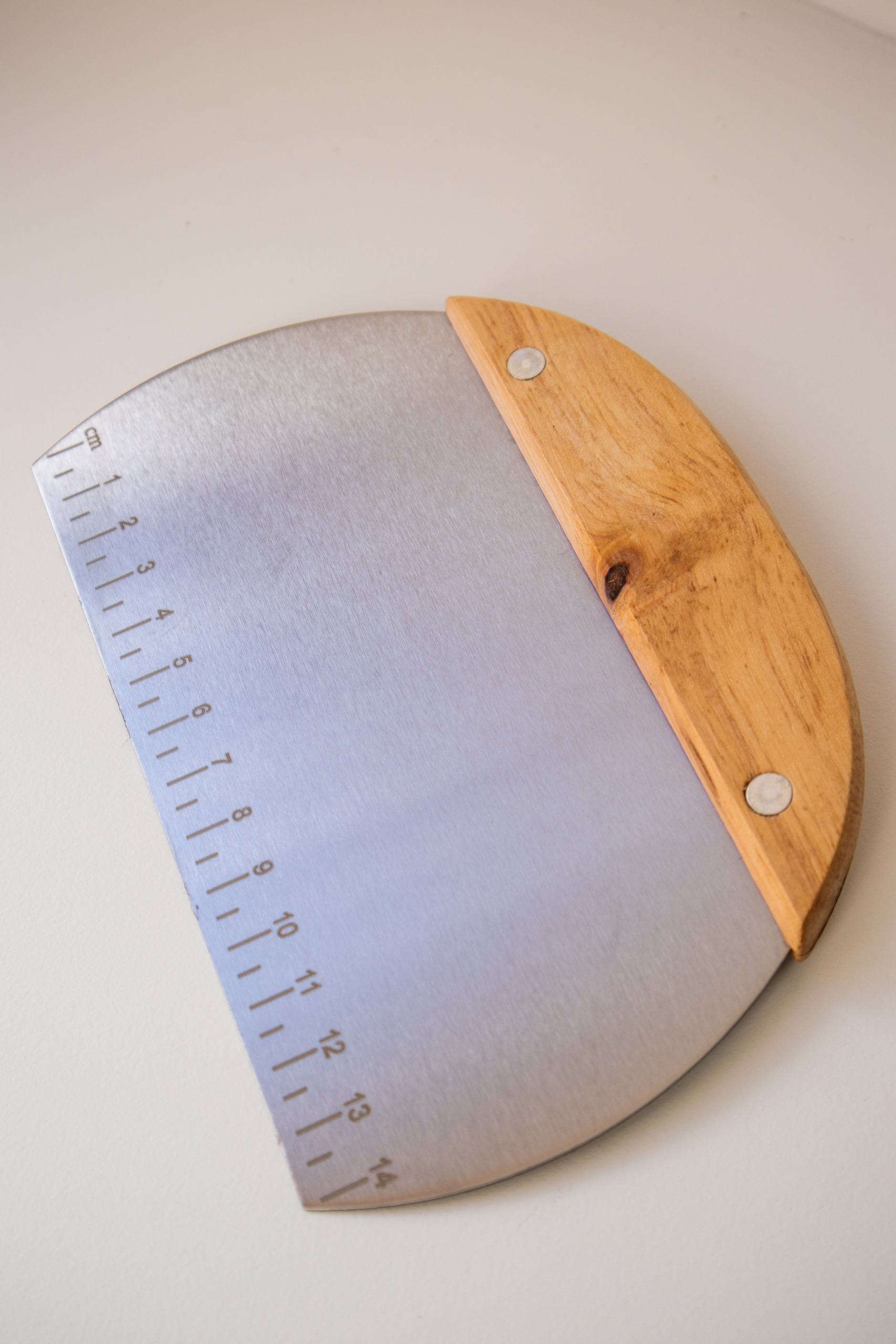 Teigkarte rund auf weißem Untergrund mit Holzgriff